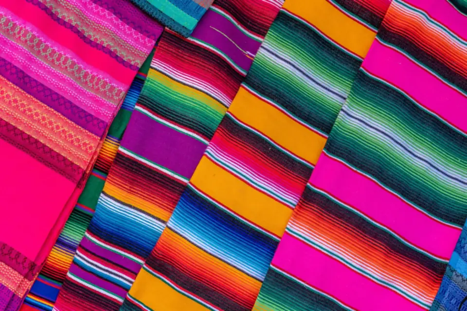Overlapping woven textiles with bright stripes.