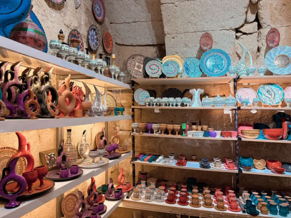 Colourful ceramics displayed on shop shelves.