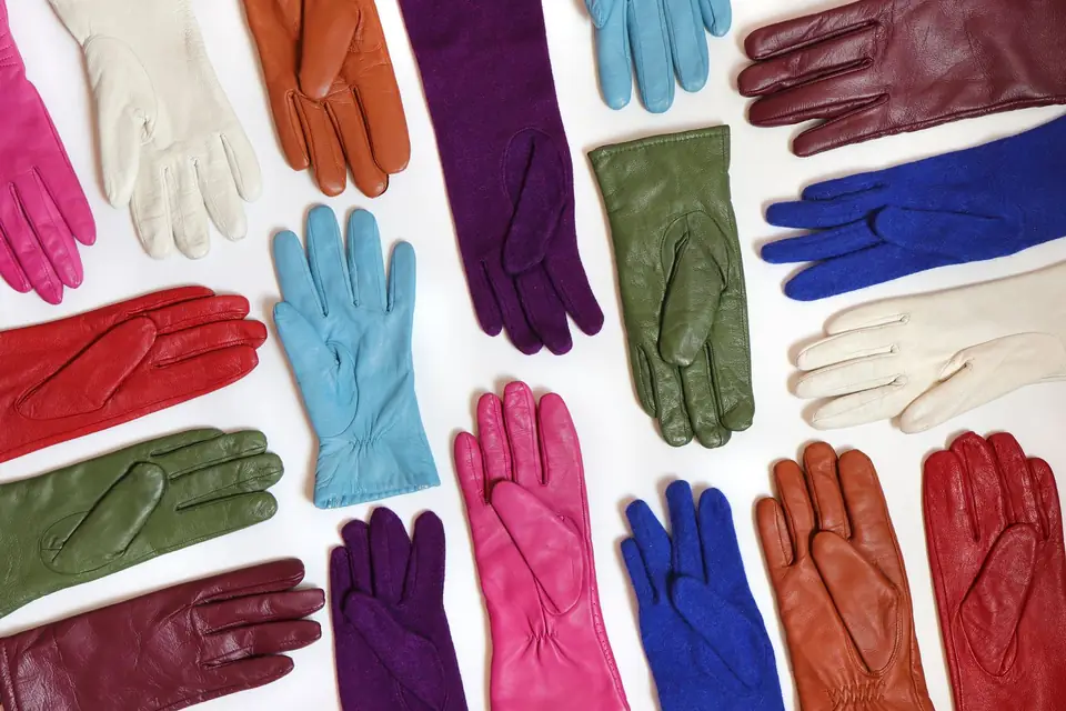 Leather gloves in assorted colours laid out flat.