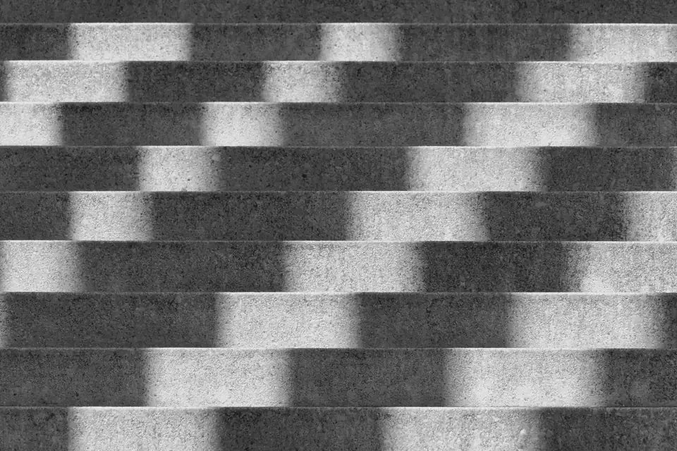 Concrete steps striped with shadow and light, black and white.