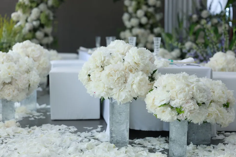 White hydrangea arrangements set on reception tables.