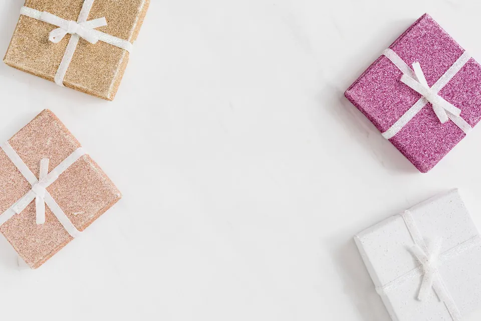 Pastel gift boxes tied with ribbons on a white background.