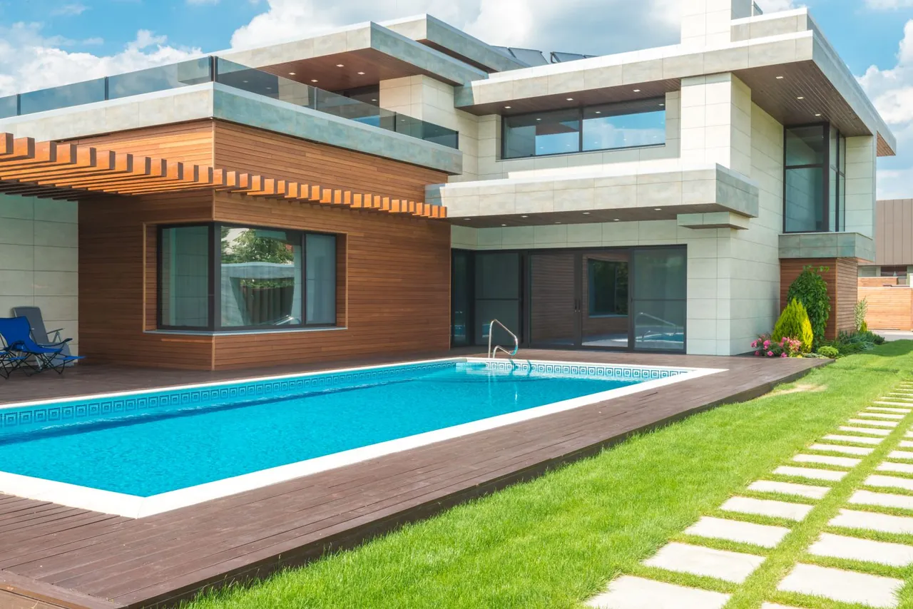 Contemporary wood and concrete house with a swimming pool and garden.