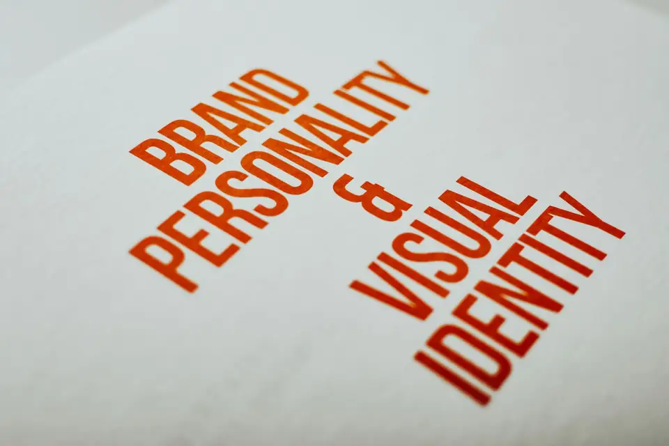 Printed page reading “Brand Personality & Visual Identity” in red letters.