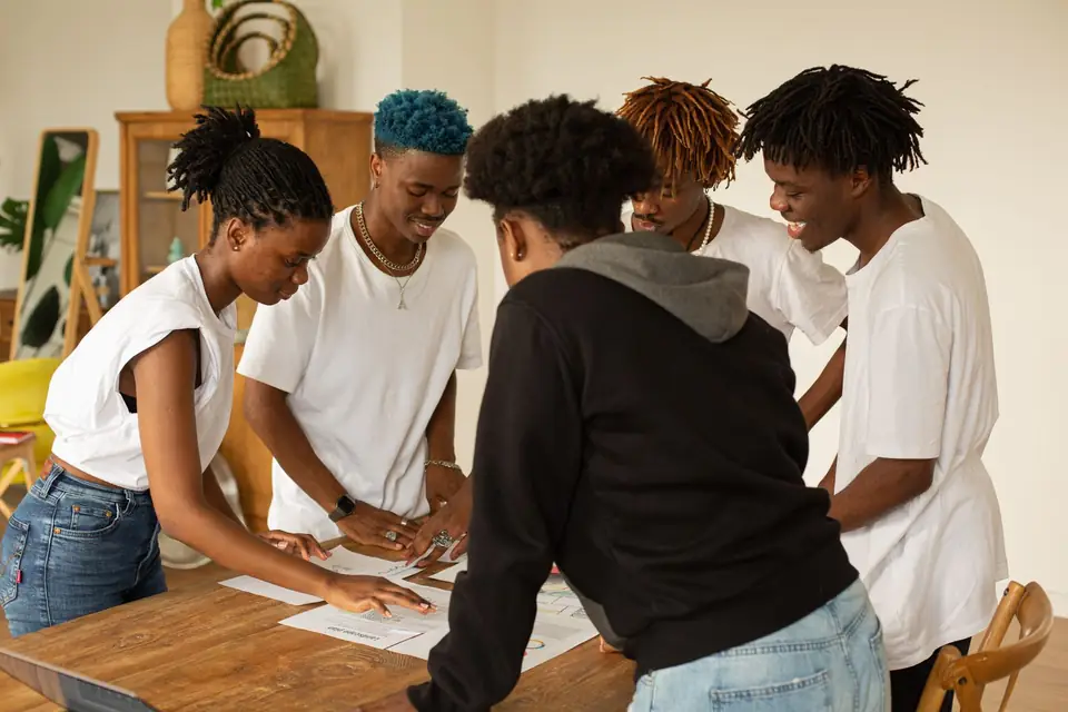 Young creatives working together around a table.