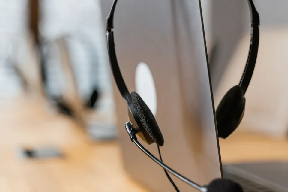 Support headset resting on a computer screen.