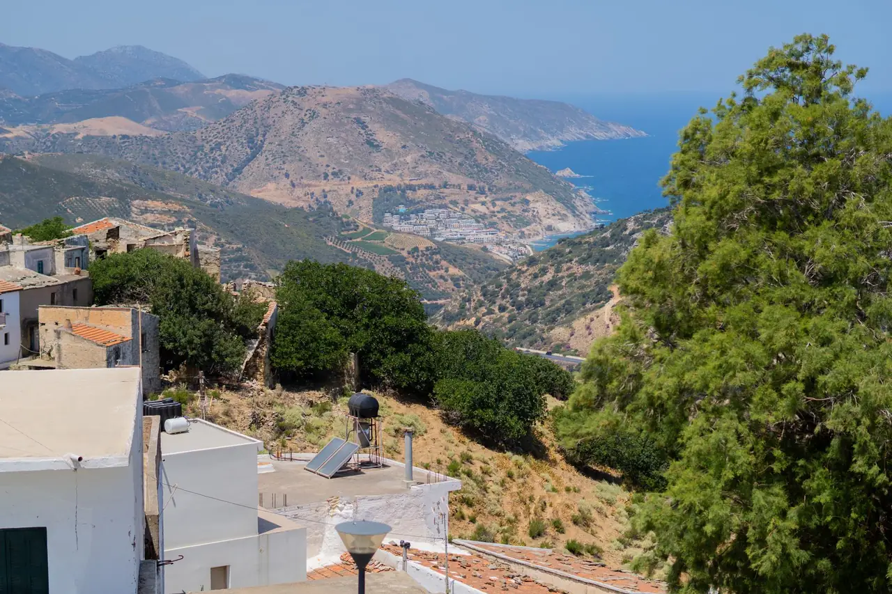 Hillside coastal village overlooking the sea and the mountains.