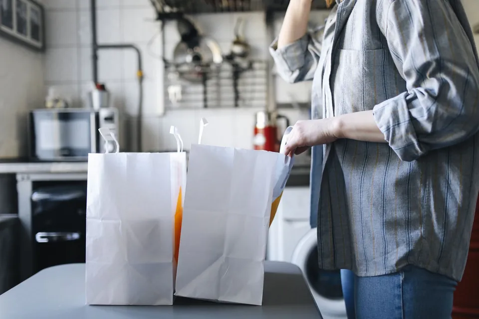 White paper bags prepared on a counter for an order.