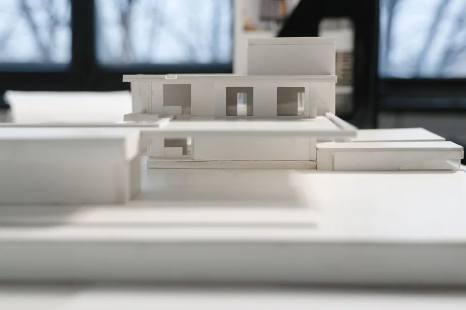 White model of a contemporary house on a studio table.