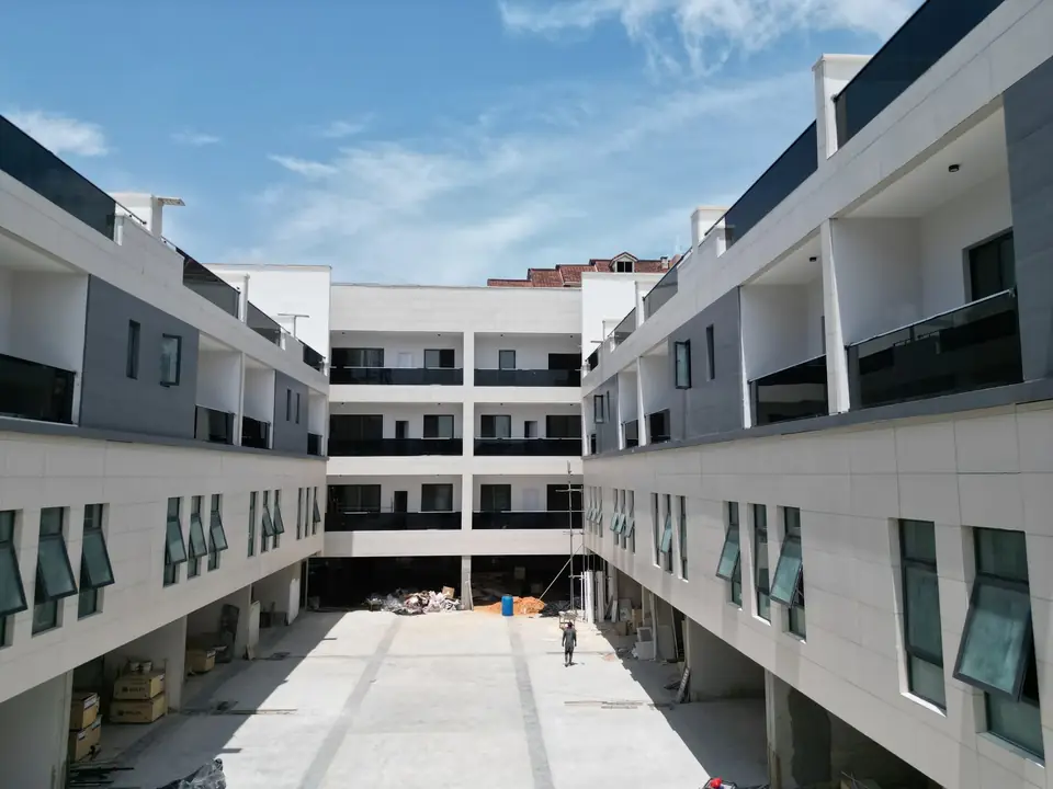Modern residential building nearing completion.