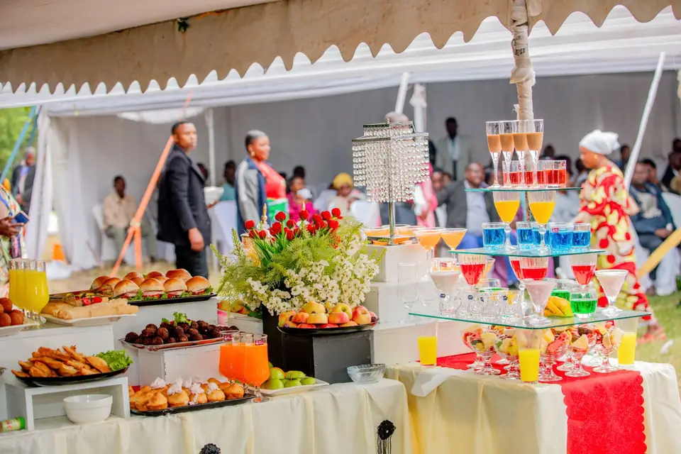 Colourful buffet set up under a tent for an event.