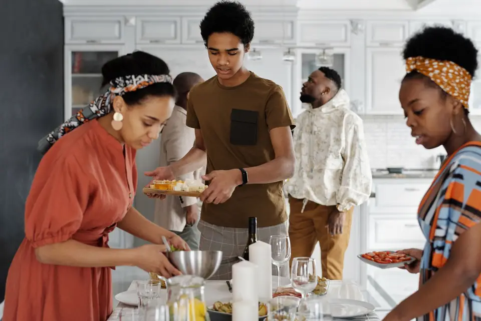 Family preparing a meal together in a kitchen.