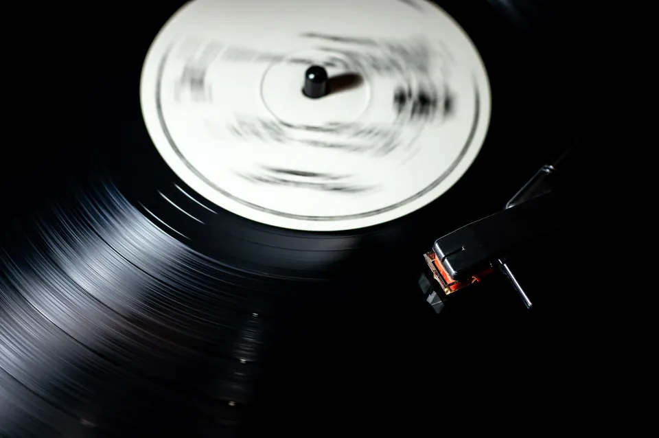 Vinyl record spinning on a turntable, close up.